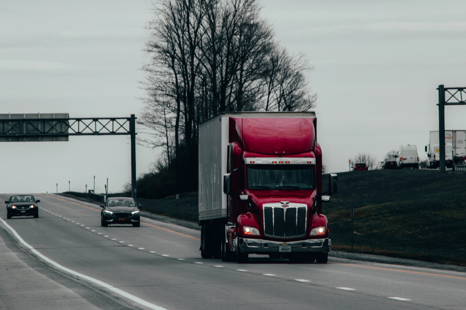 Commercial semi truck and trailer travelling on a highway